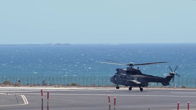 Military Helicopter Taking Off on Maritime Patrol Mission Above Atlantic Ocean Corridor in Canary Islands Spain