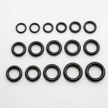 An overhead shot of multiple rows of O-rings arranged neatly on a plain surface