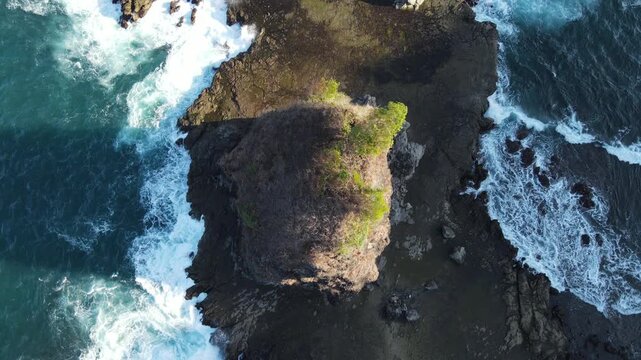 Aerial View of Watulumbung Beach with Rocky Islet and Flat Rock Platform at Sunset, Yogyakarta, Indonesia