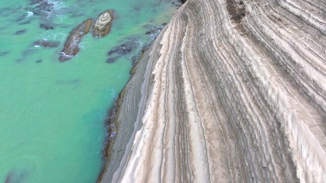 Scala dei Turchi, or the Turkish stairs in Sicily, Italy. Aerial Drone Shot. Unique White Rocks and Turquoise water.