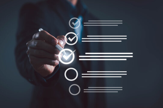 Business person using digital pen to check mark on virtual checklist for project management and quality assurance. Corporate workflow, task completion, productivity, and professional service concept.