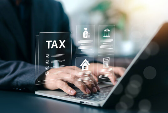 Professional business person using a laptop for tax planning and financial document management with digital icons. Corporate strategy, business administration, and investment technology concept.