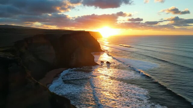 Golden sunset over a rugged coastline with dramatic cliffs, silhouetted rock formations, and glowing ocean waves under a cloudy sky Keywords: sunset, coastline, cliffs, ocean, sea, waves, water
