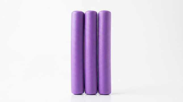 Three purple cylindrical objects on a white background, close-up product photography