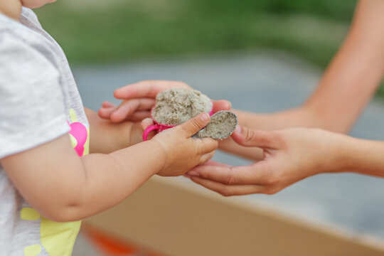 Toddler Sharing Sand Toy During Cooperative Sandbox Play