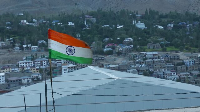 Indian flag in front of mountains in Padum town in Kargil District at Zanskar Valley, Ladakh, India. Indian flag waves in the kargil district Himalayas. Indian flag for Independence Day of India