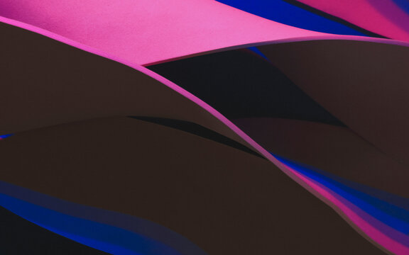 Wavy shapes illuminated by pink light, studio shot photo