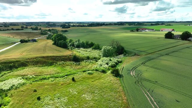 Aerial flight over a green european countryside