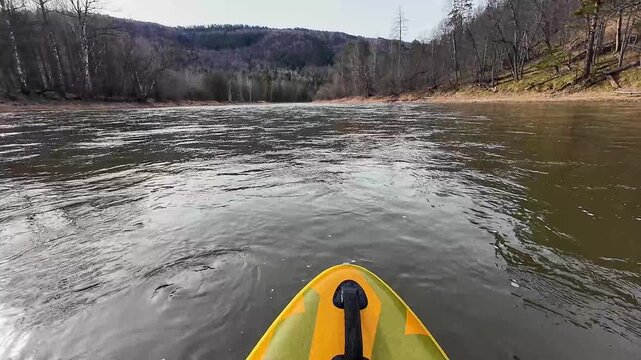 Calm boat on distant waters. Quiet vessel navigating open valley waters bordered by hills. Tranquil kayak drift across vast water body surrounded by hills and leafless trees