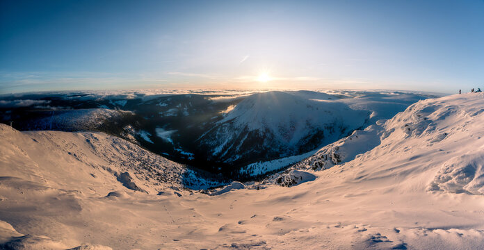 Panoramic winter view of deep mountain valleys fading into twilight dusk, Krkonose National Park.