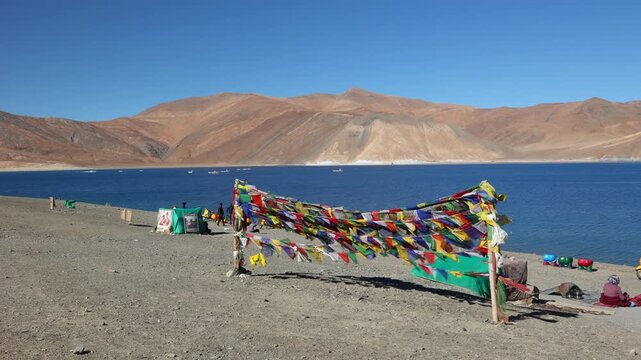 Scenic Pangong Tso lake at Leh Ladakh India with tourists. Lake extends from India to Tibet. Leh, Ladakh, Manali Jammu and Kashmir, India. 3 idiots move was shot here