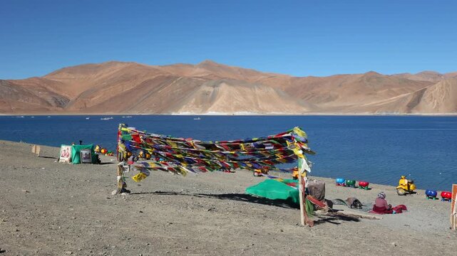 Scenic Pangong Tso lake at Leh Ladakh India with tourists. Lake extends from India to Tibet. Leh, Ladakh, Manali Jammu and Kashmir, India. 3 idiots move was shot here