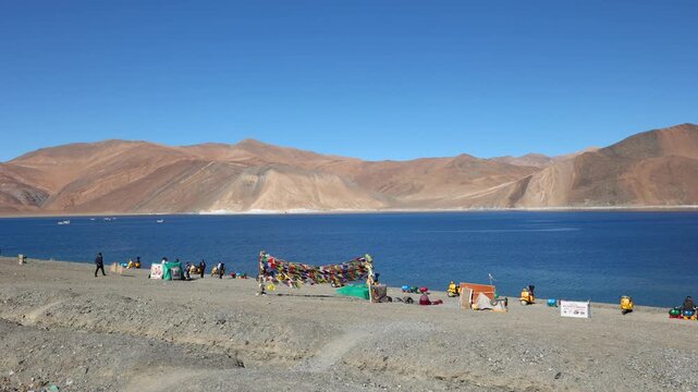 Scenic Pangong Tso lake at Leh Ladakh India with tourists. Lake extends from India to Tibet. Leh, Ladakh, Manali Jammu and Kashmir, India. 3 idiots move was shot here