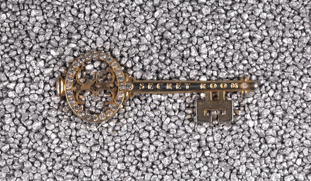 Vintage key isolated on silver sand