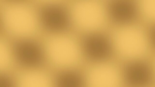 Abstract soft blurred background with warm golden and brown gradient tones.