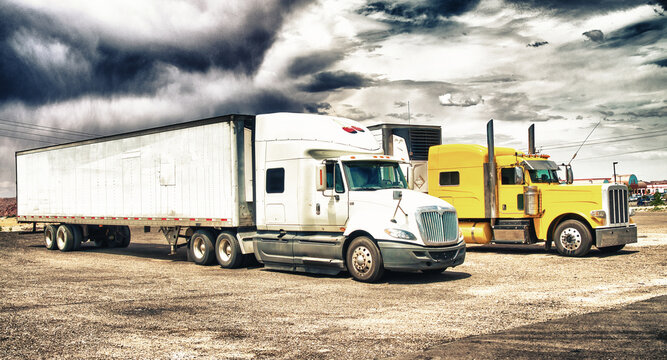 Colourful big trucks parked in the countryside