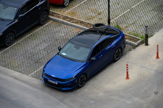July 7, 2026, Tbilisi, Georgia Modern Blue Kia K5 Sedan Parked in an Urban Parking Lot