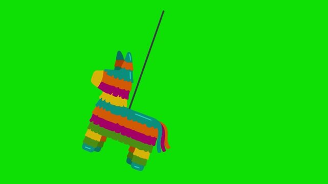 A colorful pinata in the shape of a cute animal hangs. Green background.