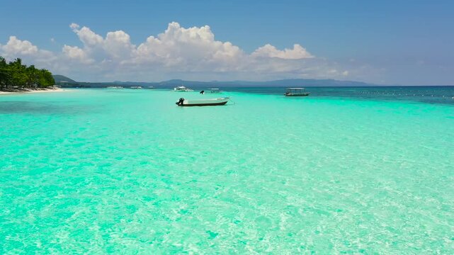 Beautiful tropical island with sand beach. Panglao, Philippines. Seascape with beautiful beach and palm trees.