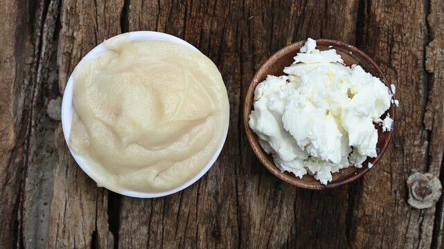Close-up of pure homemade Indian ghee (clarified butter) in a rustic bowl with a wooden spoon on a vintage wooden table. healthy eating, organic dairy, and Ayurvedic wellness.