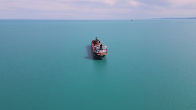 Aerial View of Cargo Ship Anchored in Calm Turquoise Sea