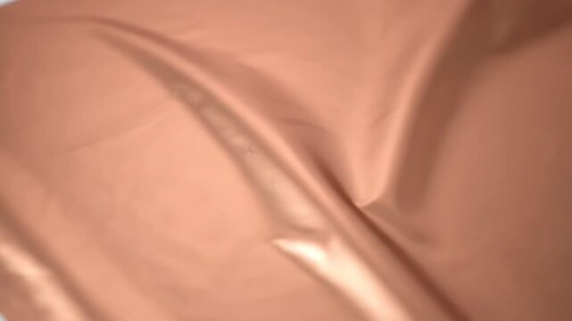 Abstract Shiny Copper Foil Background Texture with Crumpled and Wrinkled Metallic Rose Gold Surface Detail