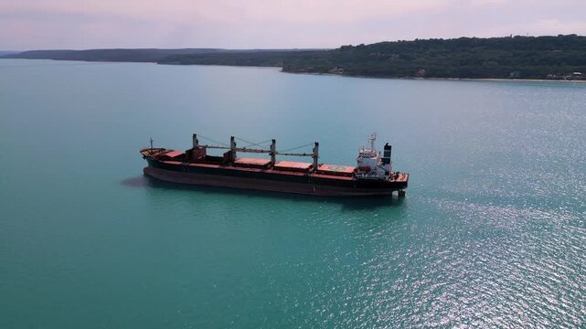 Aerial View of Large Cargo Ship Anchored Near the Coastline