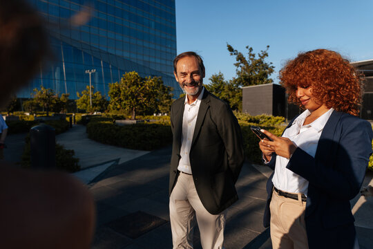 Business professionals networking in urban city park