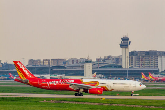 Ho Chi Minh City, Vietnam - July 6, 2024 : An Airbus A330-343 Airplane Of VietJet Air With Registration VN-A817 Taxiing At Tan Son Nhat International Airport With Terminal In The Distance.