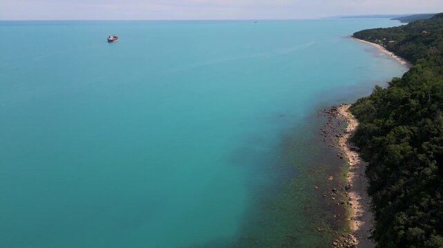Aerial View of Turquoise Sea, Sandy Beach and Green Forest Coastline