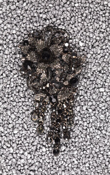jewelry brooch isolated on silver sand