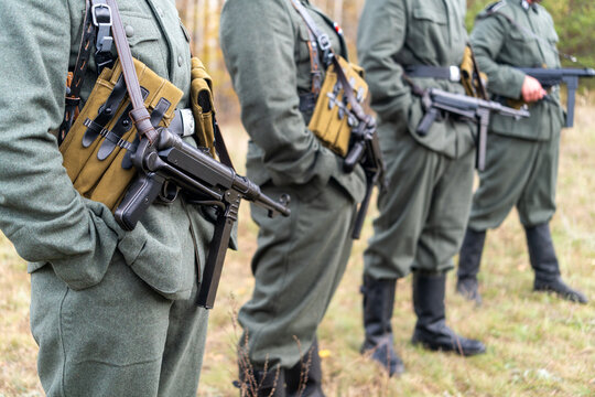 World War II German soldier holding an submachine gun in a forest. Historical military reenactment