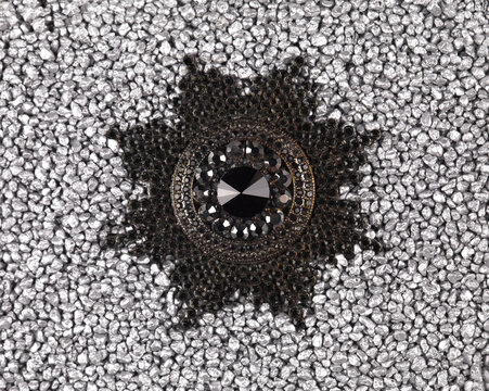 jewelry brooch isolated on silver sand