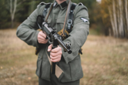 World War II German soldier holding an submachine gun in a forest. Historical military reenactment