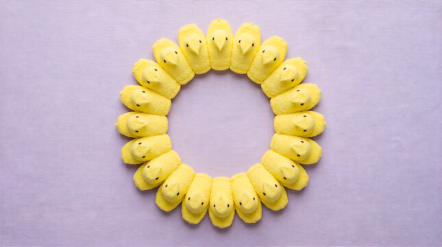 Yellow easter peep candy wreath on purple textured background