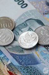 Indonesian rupiah money bills and coins on table. Indonesia cash of IDR currency © Larysa