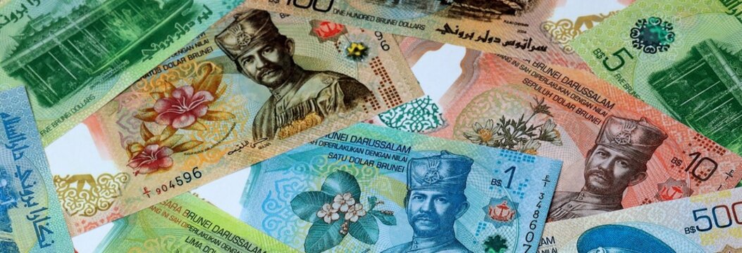 Brunei dollar money banknotes bunch on table. Brunei bills of BND currency close up