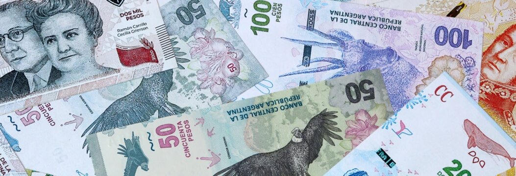 Argentine peso money banknotes bunch on table. Argentina bills of ARS currency close up