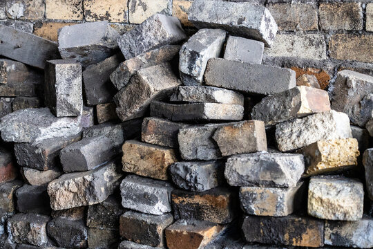 pile of knocked down bricks near brick wall