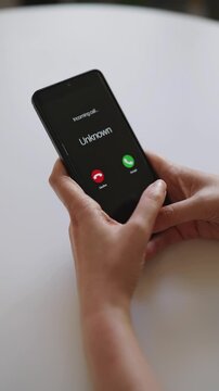 Smartphone screen displaying incoming call from unknown caller.