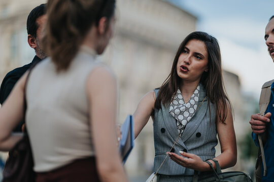 Two professionals are engaged in a serious discussion on a city street. The scene shows a corporate collaboration conversation between colleagues outdoors.