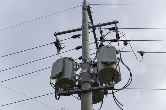 Electrical Utility Pole Supporting Two Transformers and Power Lines