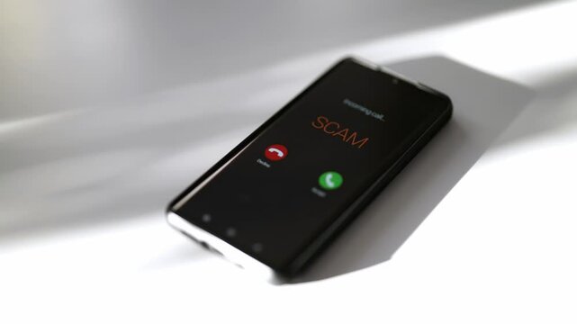 Close-up of smartphone screen displaying dangerous incoming scam call.