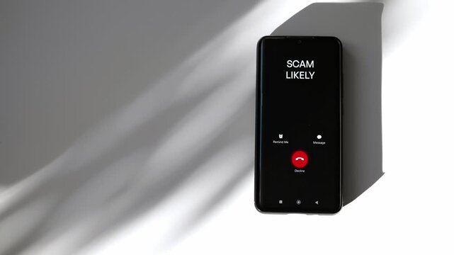 Close-up of smartphone screen displaying dangerous incoming scam call.