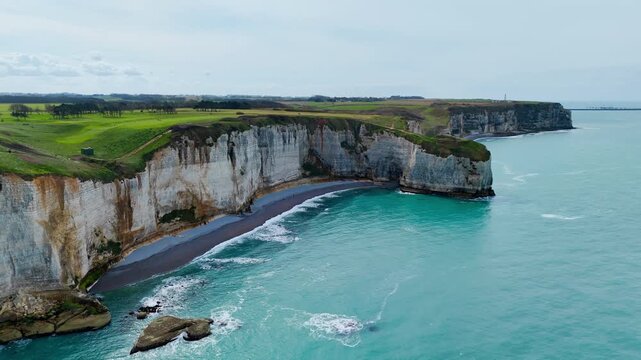 Natural coastal formations near Etretat, France, including chalk cliffs, sea arch and rock stack shaped by long-term erosion