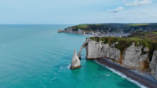 Etretat chalk cliffs and natural arch on Normandy coastline, France. Drone footage of French seaside landmark