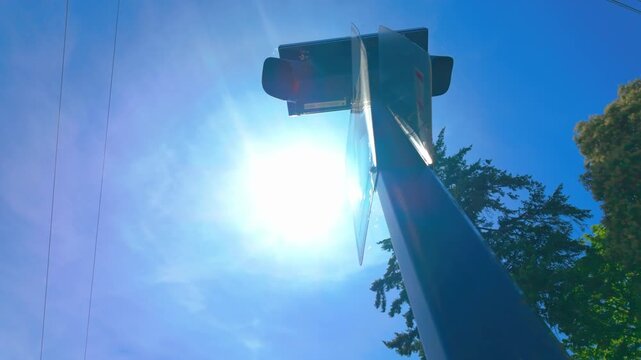 Low angle view of a standard white pedestrian crossing sign showing a walking figure icon
