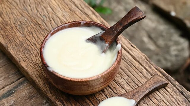 pure OR desi ghee also known as clarified liquid butter. pure OR desi ghee in bowls on an old wooden table.