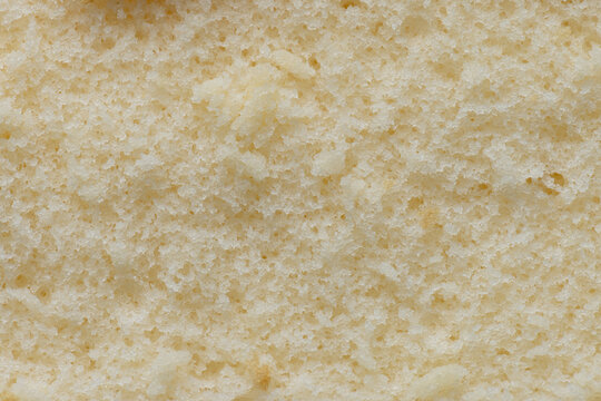 Close-up texture of soft yellow chiffon cake,A macro view showing the fine, porous, and fluffy texture of a freshly baked golden chiffon sponge cake.