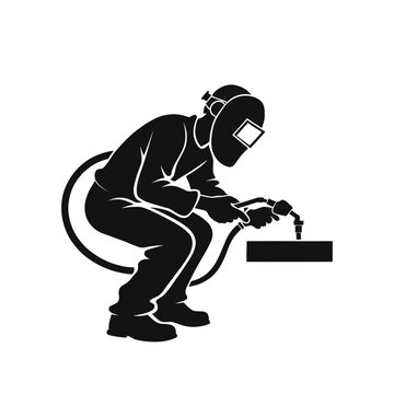 Welder carefully fuses metal parts together using a high temperature industrial welding torch.